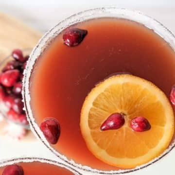 Christmas punch no alcohol in glass with orange slice and cranberries